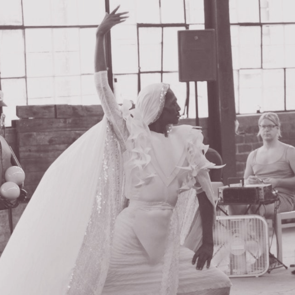 Black and White circus act with person striking a pose